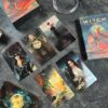 A set of vibrant oracle cards lies on a dark surface, each with mystical imagery. The "W.I.T.C.H." box hints at a magical and empowering theme, inviting you into the enchanting world of witchcraft.